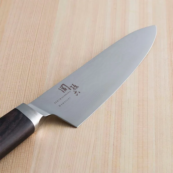 関孫六 ダマスカス 牛刀 180mm の刃に浮かぶダマスカス模様と関孫六の刻印のアップ